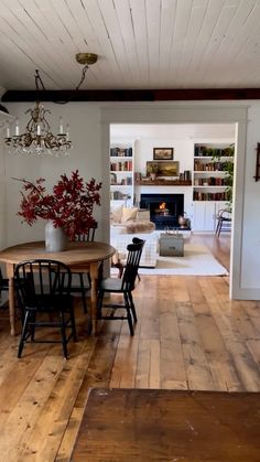 a dining room with wooden floors and white walls