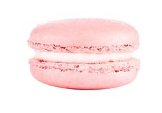 a pink macaroon sitting on top of a white surface