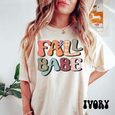 "Pumpkin Fall Tshirts Women, Pumpkin Shirt, Women's Graphic Tee, Cute Fall Shirts, Thanksgiving Shirt, Pumpkin spice Save by bundling! We offer these great discounts on bulk orders: - 25% on 5+ items (use code BUNDLE5) - 30% on 10+ items (use code BUNDLE10) - 35% on 20+ items (use code BUNDLE20) ➭ How to Order 1. Choose your shirt size & color options. 2. Select the quantity. 3. Click \"Add to Cart.\" 4. Listen for a knock at your door! ➭ Care Instructions Wash your shirt inside-out in cold/warm Fall T-shirt With Lettering, White Shirt With Text Print For Fall, White T-shirt With Lettering For Fall, Retro Tops With Funny Print For Fall, Trendy Fall Tops With Lettering, Trendy Fall Tops With Graphic, Trendy Tops With Lettering For Fall, Cute Multicolor Fall T-shirt, Retro Slogan T-shirt For Fall