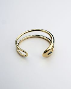 The Formation Wrist Cuff is an essential styling piece. Based on the shape of our Organic Long Hoops and wrapped into a modern wrist cuff form, this is a timeless piece that will elevate any outfit. Wear it with other styles from our core collection. DETAILS: High micron, ethically sourced 18K gold certified by LBMA Responsible Gold to meet international ethics standards. Eco brass base metal with 18K gold plating or solid 925 sterling silver. 6 months warranty Nickel free. Packaged in F+H brand F H, Gemstone Choker, Black Gift Boxes, Wrist Cuffs, Branded Gifts, Adjustable Necklace, Topaz Gemstone, White Topaz, Base Metal