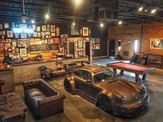 an old car is parked in front of a pool table