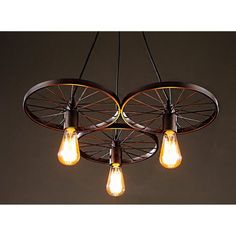 three light bulbs are hanging from a chandelier that has wheels on the sides