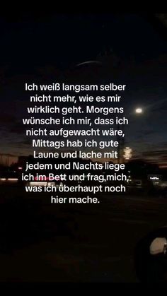 an image with the words in german and english on it at night, next to a street light