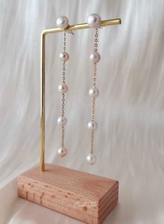 These earrings are crafted entirely from natural freshwater pearls, elegantly linked together to dangle beautifully. The pearls have a stunning luster and soft tones, appearing especially radiant under sunlight. The top stud part is made of S925 sterling silver and can be detached to wear as simple pearl studs, or connected to create longer dangle earrings. This versatile design is convenient and perfect for any occasion.  P E A R L ∙ E A R R I N G S ✨Total Length : about 8- 8.5 cm  Pearl Size: 5-8mm ✨Color: natural untreated, metallic white with tint of pink overtone ✨Material: Ear studs are gold plated S925 sterling silver, suitable for sensitive skin.  It is nickel free, hypoallergenic, tarnish resistant O T H E R ∙ I N F O R M A T I O N ✨ Our pieces are made with care and attention to Akoya Pearl Drop Dangle Earrings, Akoya Pearl Dangle Earrings In Pearl White, Akoya Pearl Dangle Earrings, Pearl White Akoya Pearl Dangle Earrings, Akoya Pearl White Dangle Earrings, Dangle Akoya Pearl Earrings For Gift, Akoya Pearl Dangle Earrings For Anniversary, Akoya Pearl Dangle Earrings Gift, Gift Akoya Pearl Dangle Earrings