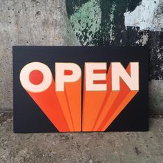 an open sign painted on the side of a building