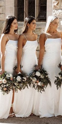 the bridesmaids are all wearing white dresses and holding bouquets in their hands