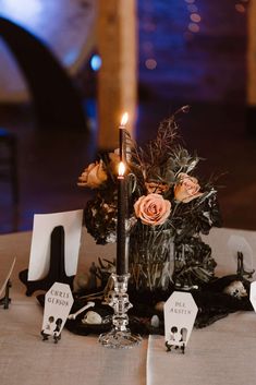 a table with candles and place cards on it