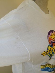 a white t - shirt with an image of a hot air balloon on it's chest