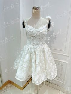 a white dress on display in front of a mirror