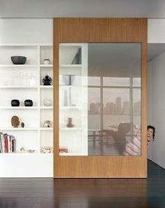 an empty room with bookshelves and shelves on the wall