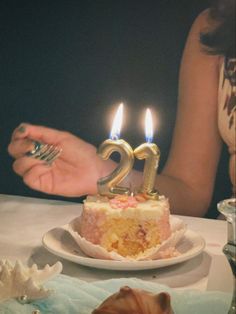 a cake with two candles on top of it