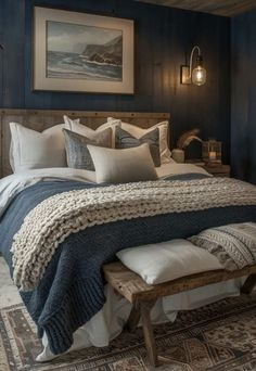 a bedroom with blue walls and white bedding