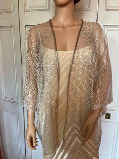 This is a beautiful hand made lace kimono ideal as a cover-up for weddings or special occasions. The lace is champagne floral. It has a satin edging. It can be made in any size from 8 to 24 (UK sizes). It is made in the UK. It is normally sent out to you within 5 days, but I am very happy to make your order a priority if you need it urgently. Just let me know the date needed by. Postage is free in the UK! International postage is £9. I am happy to exchange items or refund your payment if you are Elegant Gold Kimono, Long Lace Kimono With Lace Trim, Party Lace Top In Cream, Party Lace Top With Lace Trim In Beige, Beige Lace Trim Top For Party, Elegant Open Front Summer Shrug, Beige Lace Top For Spring Wedding, Spring Wedding Open Front Kimono, Elegant Cream Lace Top For Party