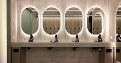 a row of sinks with mirrors above them