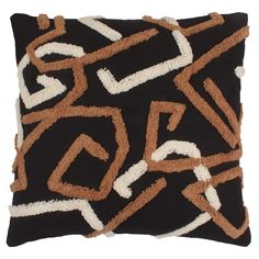 a black pillow with brown and white designs on it