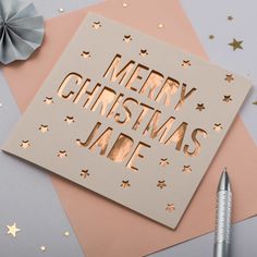 a christmas card with the words merry christmas jafe on it next to a pen