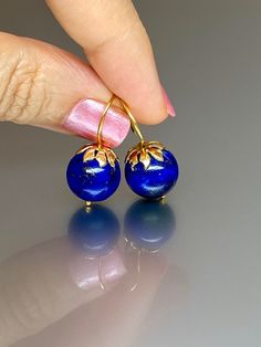 Beautiful vibrant and high-grade lapis lazuli globe earrings. The 12.5 mm lapis lazuli globes have a gorgeous deep vibrant royal blue color that shows celestial flecks of golden pyrite in the stone. The ultra-fine globes attached to a beautiful 14K gold-filled flower caps as they dangle from the 14k gold-filled ear wires. These are elegant and perfect earrings to go with any outfit. A pair of fine gemstone essentials. *Ball size (diameter): 12.5 mm *Metal: vermeil on sterling *Earrings drop leng Blue Lapis Lazuli Earrings For Formal Occasions, Formal Blue Lapis Lazuli Earrings, Blue Lapis Lazuli Earrings For Gift, Blue Lapis Lazuli Earrings, Pierced Lapis Lazuli Round Jewelry, Disco Ball Earrings, Globe Earrings, Royal Blue Earrings, Lapis Jewelry