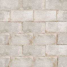 a white brick wall textured with cement