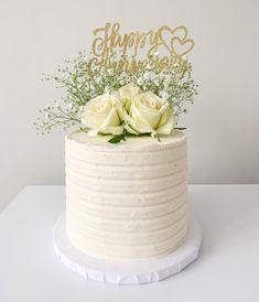 there is a white cake with flowers on top