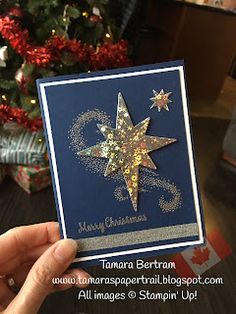 someone holding up a christmas card with a star on it