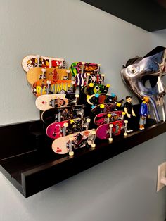 there are many skateboards and helmets on the shelf