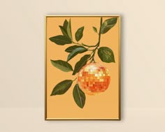 an orange with green leaves hanging from it's side in front of a yellow wall