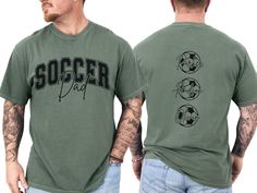 a man with tattoos wearing a green soccer t - shirt