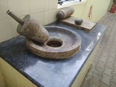 two stone sinks in a public restroom, one with a hammer and the other without