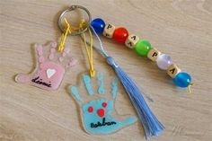 a keychain with a hand print on it and a tassel hanging from the end