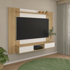 a flat screen tv mounted on a wall in a living room with a green rug