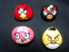 four angry birds painted on rocks sitting next to each other