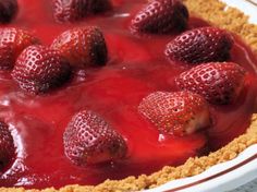 a close up of a pie with strawberries on top