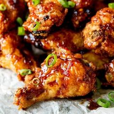 chicken wings with sauce and green onions on the side, ready to be served or eaten