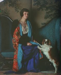 an old photo of a woman and her dog