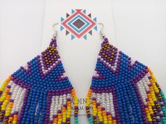 "Beautifully handmade Native American Style Seed Bead Earrings with woven in a combination of desert and mountain colors. Traditional native style design at nearly 6\" off the ear. Colors and styling great for matching your favorite dancing regalia or to wear on its own. Made with stainless steel ear wires and genuine high quality beads. All handmade and Shipped Free from Hawaii with Aloha!" Fair Trade Multicolor Beaded Earrings For Festival, Multicolor Fair Trade Beaded Earrings For Festival, Traditional Purple Beaded Earrings For Festivals, Artisan Purple Beaded Earrings, Handmade Southwestern Multicolor Earrings, Handmade Southwestern Multicolor Beaded Earrings, Handmade Multicolor Southwestern Beaded Earrings, Southwestern Multicolor Beaded Earrings For Beach, Southwestern Multicolor Beaded Earrings