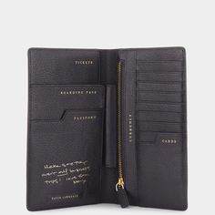 a black leather wallet with gold lettering on the front and side, open to reveal an id