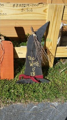 the witch is in sign next to wooden boxes