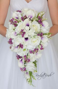 a bridal holding a bouquet of white and purple flowers