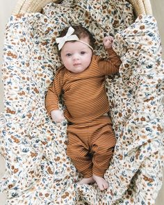 a baby is laying down in a basket