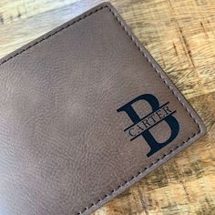 "Our LEATHERETTE Wallet is custom engraved to order. This makes a memorable gift for Teen Son, Grandson, Nephew Gift, Ect. Choose any of our popular designs or send us your own custom wording to be engraved. Comes GIFT BOXED ready to gift! This is a perfect gift for any occasion for the special guy in your life. ♥ ♥ ♥ I T E M . I N F O R M A T I O N ♥ ♥ ♥ ♥ Leatherette vegan Wallet ♥ All Names and Initials will be engraved in the font shown in each design. We can engrave your text, name, dates, Personalized Classic Leather Wallets, Classic Personalized Leather Wallets, Classic Personalized Wallets, Personalized Rectangular Leather Wallet, Personalized Leather Wallet Rectangular, Rectangular Wallet With Engraved Logo As Gift, Customizable Rectangular Wallet For Personalized Gifts, Classic Personalized Rectangular Wallets, Classic Personalized Rectangular Wallet