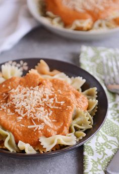 a plate of pasta with sauce and parmesan cheese