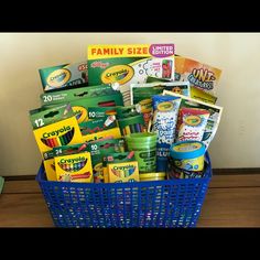 a blue basket filled with lots of school supplies