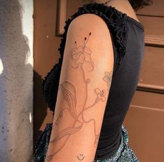 a woman with a flower tattoo on her arm