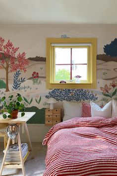 a bedroom with a red and white bedspread sitting next to a window on the wall