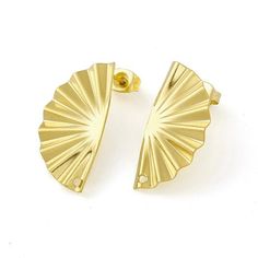 a pair of gold earrings on a white background