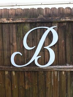 a wooden fence with the letter b painted on it