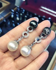 We are presenting you a HUGE pair of CHANDELIER, Genuine, White & Black South Sea Pearls, extremely FINE AA+, LUSTROUS and Rare! Accenting the 4 pearls are 60 pieces of E/VS Natural diamonds, weighting a total of 0.90 carat. Set in fabulously designed 18K solid white gold earrings ONLY ONE ITEM AVAILABLE!! NO DUPLICATES!! WHAT YOU SEE IN THE PICTURES IS WHAT YOU WILL GET SOLIDLY HANDCRAFTED EARRINGS! SUGGESTED RETAIL VALUE: $8,580 PEARLS: Size: White 13 mm, Black 11 mm Shape: Round Color: Bl Luxury Black Pearl Earrings Gift, Luxury Black Pearl Earrings For Gift, Golden South Sea Pearls, Vs Diamond, Sea Pearls, South Sea Pearls, White Gold Earrings, Pearl Diamond, Handcrafted Earrings