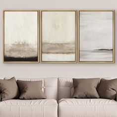 three paintings hang on the wall above a couch in a living room with neutral colors