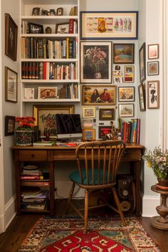 a desk with a chair, bookshelf and pictures on the wall above it