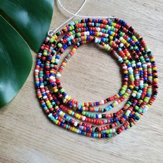 This colorful waistbead was made with multicolored glass seed beads.Waistbead length: 50 inches Strung on strong, cotton cord with 2 clear anchor beads (for adjustment) and 2 knots. Tie on, permanent waistbeads. Waist beads have been worn for centuries in African tradition, and the uses are endless. From adornment and weight management, all the way to signs of maturity and femininity, the diversity of waist beads make them appealing pieces of jewelry to own. They are generally worn under a garme Multicolor Waist Beads For The Beach, Multicolor Waist Beads For Beach, Multicolor Round Waist Beads For Beach, Colorful Waist Beads For Festivals, Adjustable Multicolor Waist Beads With Large Beads, Colorful Heishi Waist Beads, Rainbow Letter Beads For Festival, Adjustable Large Bead Waist Beads For Beach, Rainbow Heishi Beads For Festival